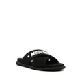 Moschino logo-embossed crossover-strap sandals - Black