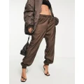 adidas Originals Luxe Lounge repeat logo woven trackies in brown