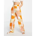 Monki patterned patchwork pants in orange