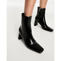 Glamorous mid heel ankle boots in black patent