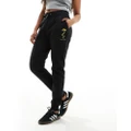 Armani Exchange trackies with dragon print in black