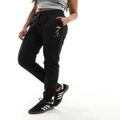 Armani Exchange trackies with dragon print in black
