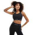 New Balance linear logo medium support sleek sports bra in black