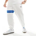 Lacoste logo trackies with contrast stripe in white