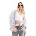 Calvin Klein Jeans woven label rib crop v-neck top in white